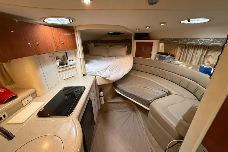 Slide: The Image of Interior of a 2000 Monterey 322 Cruiser with cozy seating and sleeping area. - 23