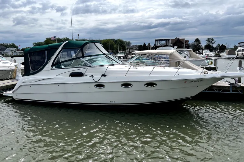 Slide: The Image of 2000 Monterey 322 Cruiser docked at a marina under cloudy skies. - 3