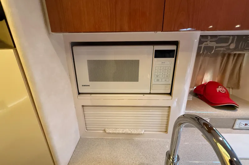 Slide: The Image of Microwave in 2000 Monterey 322 Cruiser kitchen with red cap on counter. - 30