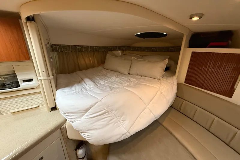 Slide: The Image of Cozy cabin interior of 2000 Monterey 322 Cruiser with bed and seating area. - 32