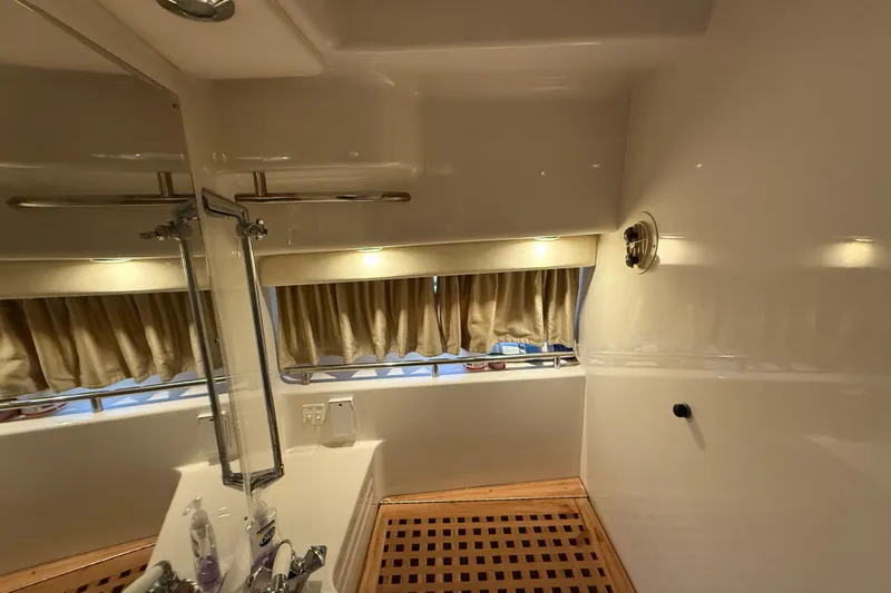 Slide: The Image of Bathroom interior of 2000 Monterey 322 Cruiser with wooden floor and mirror. - 34