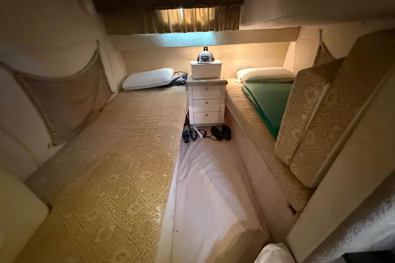 Slide: The Image of Cozy cabin interior of 2000 Monterey 322 Cruiser with twin beds and storage. - 37