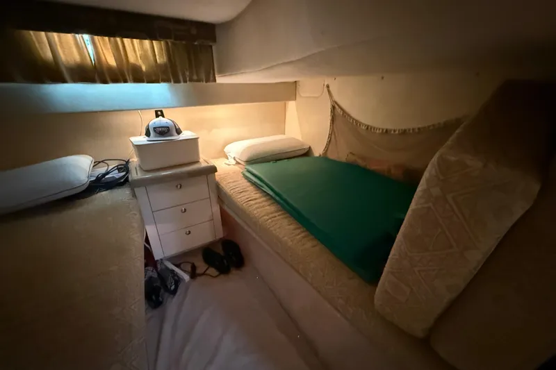 Slide: The Image of Cozy cabin interior of 2000 Monterey 322 Cruiser with bed and storage. - 39