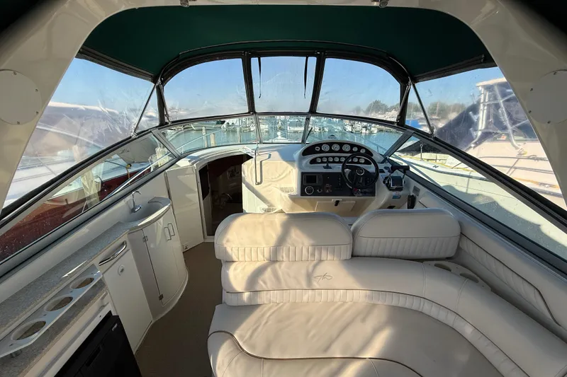 Slide: The Image of Interior of 2000 Monterey 322 Cruiser boat with helm and seating area. - 4
