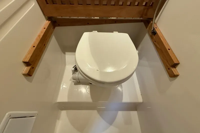 Slide: The Image of Toilet in 2000 Monterey 322 Cruiser boat bathroom with wooden accents. - 40