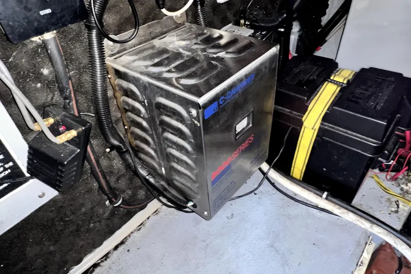 Slide: The Image of Electrical system inside a 2000 Monterey 322 Cruiser boat, featuring a battery charger. - 45