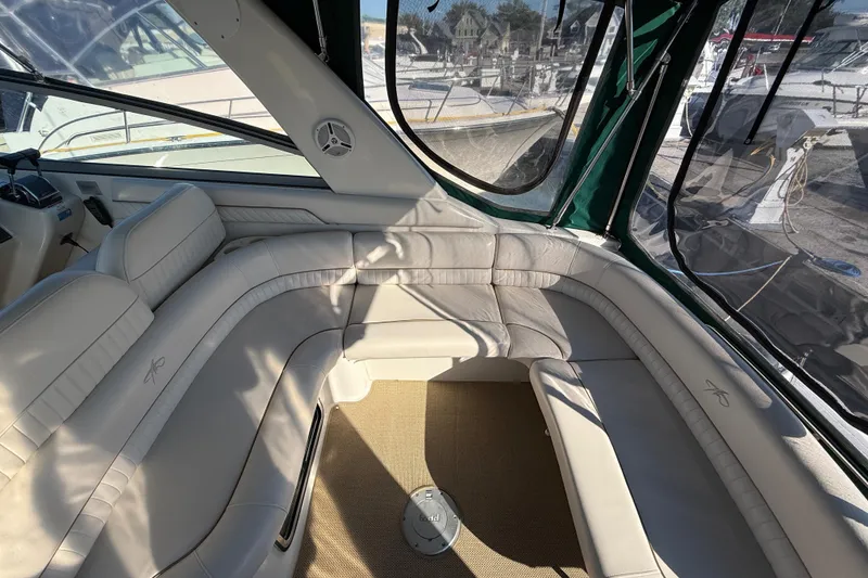 Slide: The Image of Interior of 2000 Monterey 322 Cruiser with white leather seating and panoramic windows. - 6