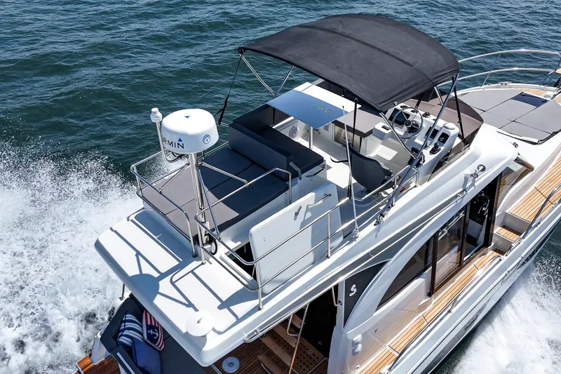 Slide: The Image of 2023 Beneteau Antares 11 Fly cruising on water, featuring flybridge and modern design. - 12