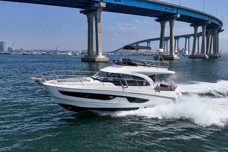 Slide: The Image of 2023 Beneteau Antares 11 Fly cruising under a bridge on a sunny day. - 15