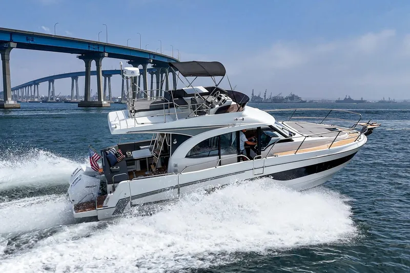 Slide: The Image of 2023 Beneteau Antares 11 Fly cruising under a bridge on a sunny day. - 18