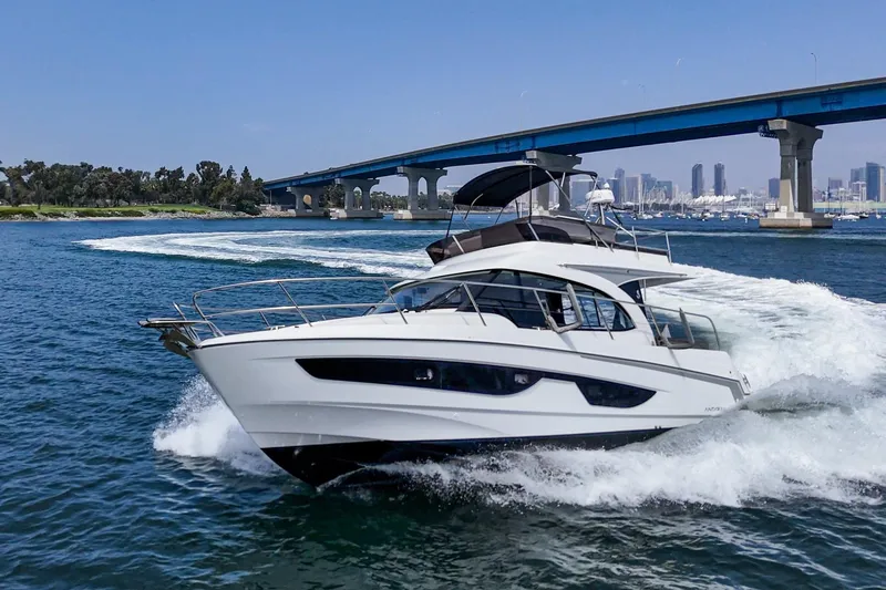 Slide: The Image of 2023 Beneteau Antares 11 Fly cruising under a bridge in a scenic waterway. - 20