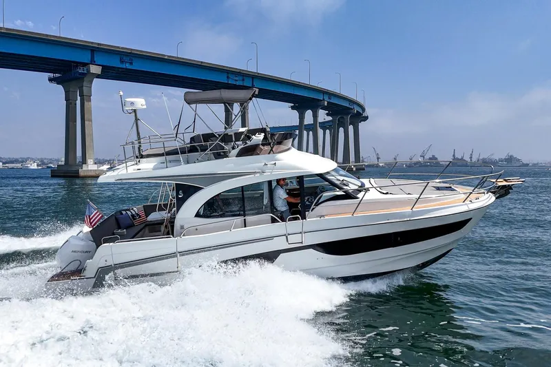 Slide: The Image of 2023 Beneteau Antares 11 Fly cruising under a bridge on a sunny day. - 22