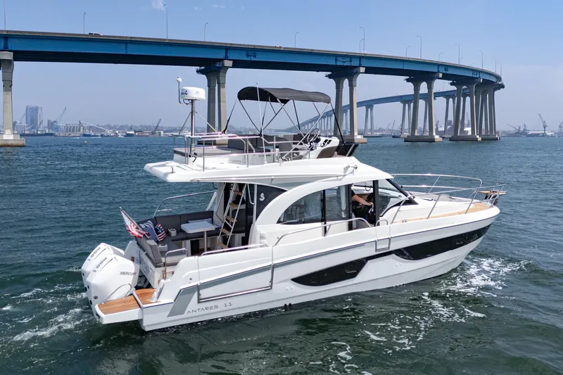 Slide: The Image of 2023 Beneteau Antares 11 Fly cruising under a bridge on a sunny day. - 27
