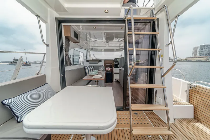 Slide: The Image of 2023 Beneteau Antares 11 Fly yacht interior with dining area and wooden stairs. - 38