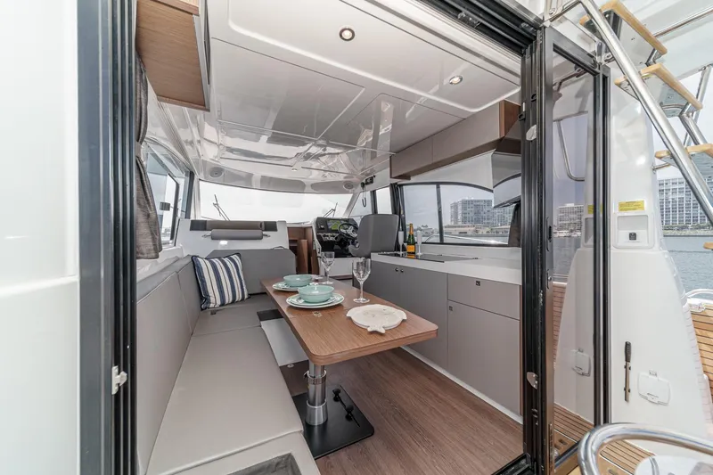 Slide: The Image of Interior of 2023 Beneteau Antares 11 Fly, featuring modern dining area and helm. - 39