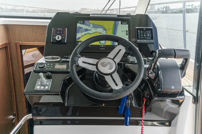 Slide: The Image of Helm of 2023 Beneteau Antares 11 Fly with navigation controls and display. - 46