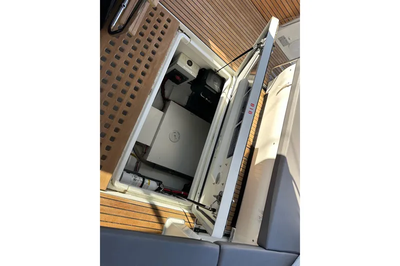 Slide: The Image of 2023 Beneteau Antares 11 Fly engine compartment with open hatch, showcasing interior details. - 66