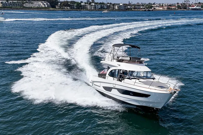 Slide: The Image of 2023 Beneteau Antares 11 Fly cruising on open water, creating a dynamic wake. - 7