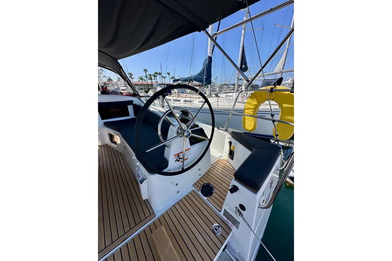 Slide: The Image of Cockpit of 2022 Jeanneau Sun Odyssey 410 sailboat with steering wheel and teak flooring. - 12