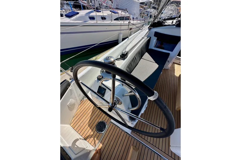 Slide: The Image of Cockpit of 2022 Jeanneau Sun Odyssey 410 sailboat with steering wheel and seating. - 15