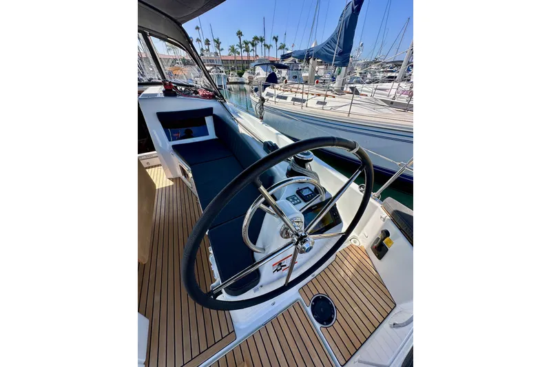 Slide: The Image of Cockpit of 2022 Jeanneau Sun Odyssey 410 sailboat with steering wheel and teak flooring. - 18