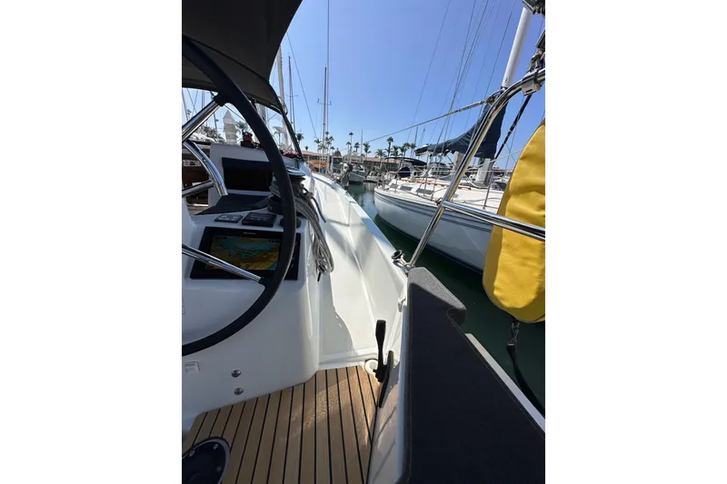 Slide: The Image of 2022 Jeanneau Sun Odyssey 410 sailboat deck with steering wheel and navigation equipment. - 21