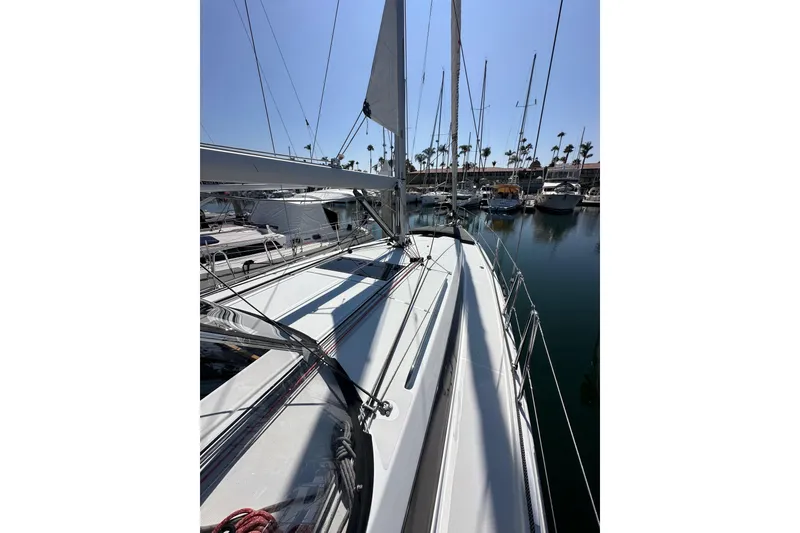 Slide: The Image of 2022 Jeanneau Sun Odyssey 410 sailboat docked in a marina, surrounded by other boats. - 23