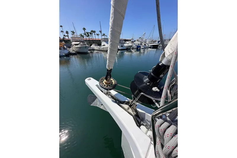 Slide: The Image of Jeanneau Sun Odyssey 410 sailboat docked in marina, 2022 model, with clear blue sky. - 27