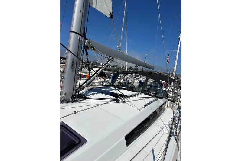 Slide: The Image of 2022 Jeanneau Sun Odyssey 410 sailboat docked in a marina under clear blue skies. - 29