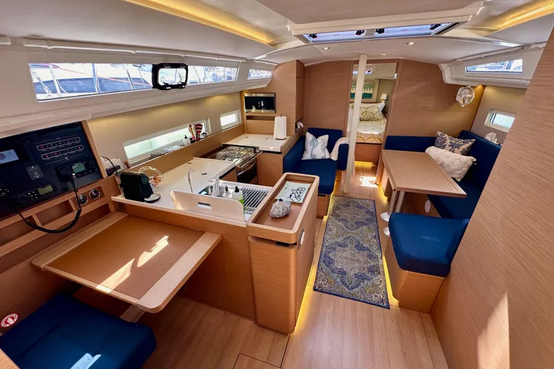 Slide: The Image of Interior of 2022 Jeanneau Sun Odyssey 410 yacht, featuring modern kitchen and cozy seating area. - 38