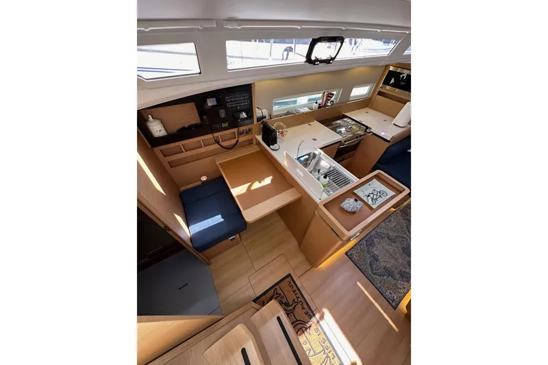 Slide: The Image of Interior of 2022 Jeanneau Sun Odyssey 410 yacht, featuring modern kitchen and seating area. - 39