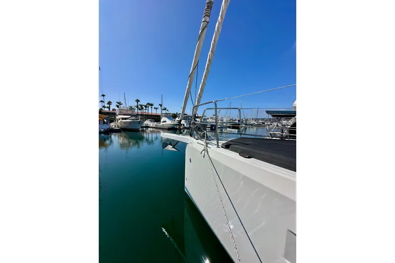 Slide: The Image of Jeanneau Sun Odyssey 410 sailboat docked in a marina, 2022 model, clear blue sky. - 4