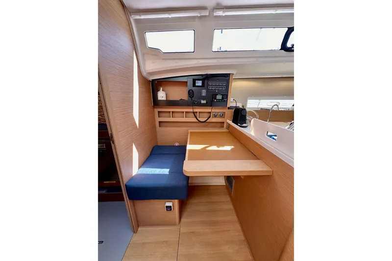 Slide: The Image of Interior of 2022 Jeanneau Sun Odyssey 410 sailboat, featuring a compact navigation station. - 40