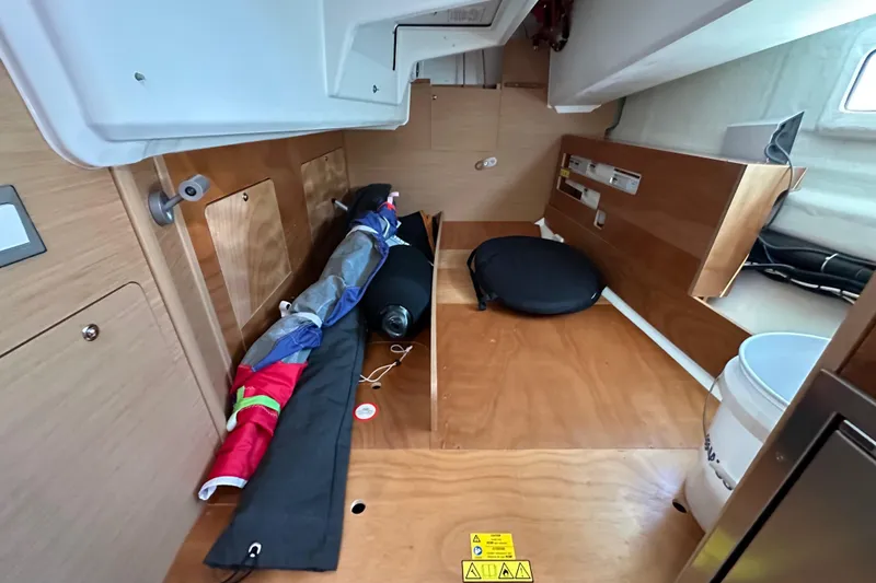 Slide: The Image of Interior storage area of 2022 Jeanneau Sun Odyssey 410 sailboat, featuring wooden cabinetry. - 43
