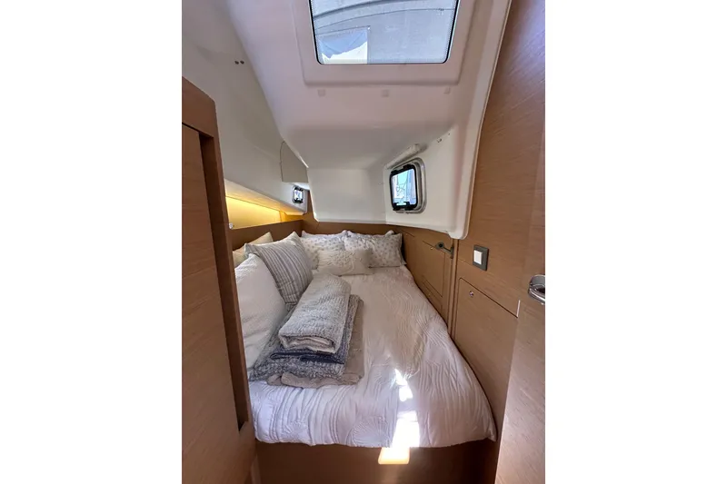 Slide: The Image of Cozy cabin interior of 2022 Jeanneau Sun Odyssey 410 sailboat with skylight and bedding. - 50