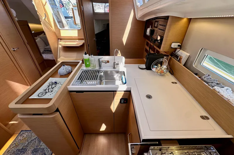 Slide: The Image of Modern kitchen interior of 2022 Jeanneau Sun Odyssey 410 yacht, featuring sleek design and amenities. - 57