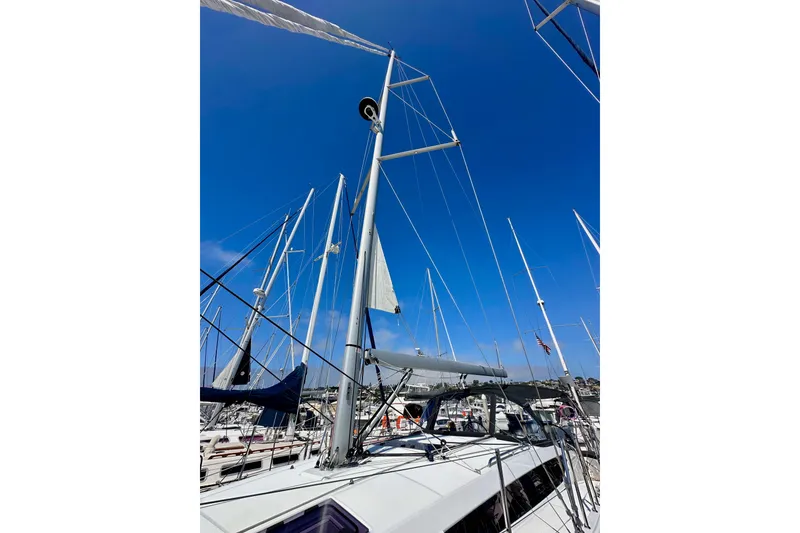 Slide: The Image of Jeanneau Sun Odyssey 410 sailboat mast against clear blue sky, 2022 model. - 6