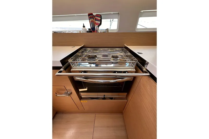 Slide: The Image of Modern kitchen in 2022 Jeanneau Sun Odyssey 410 yacht with sleek stove and oven. - 61