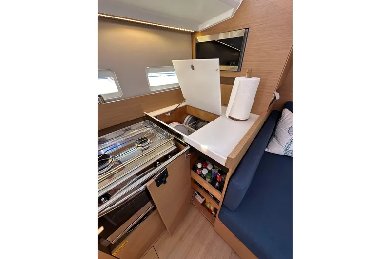 Slide: The Image of Modern kitchen interior of 2022 Jeanneau Sun Odyssey 410 yacht with stove and storage. - 63