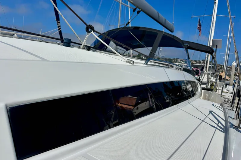 Slide: The Image of Jeanneau Sun Odyssey 410 sailboat, 2022 model, docked in a marina under clear blue skies. - 7