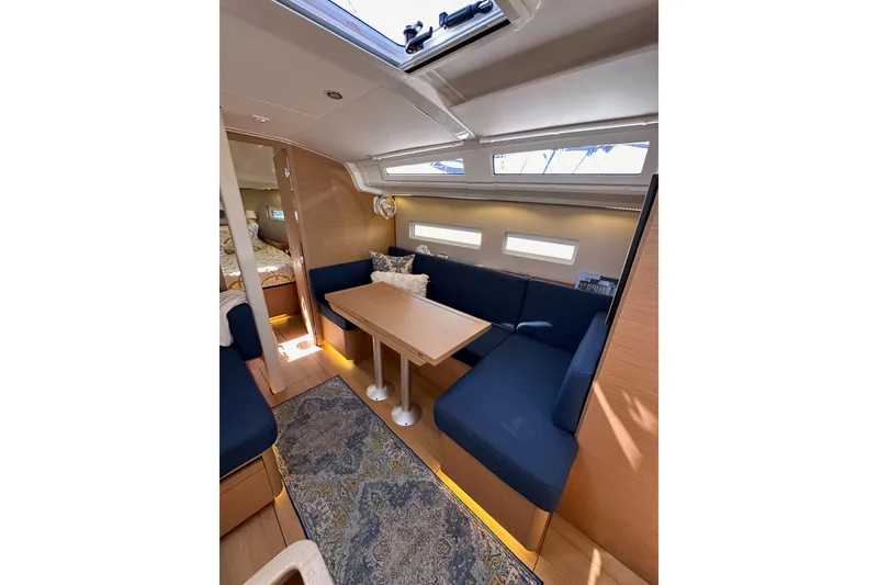 Slide: The Image of Interior of 2022 Jeanneau Sun Odyssey 410 sailboat with cozy seating and wooden table. - 72