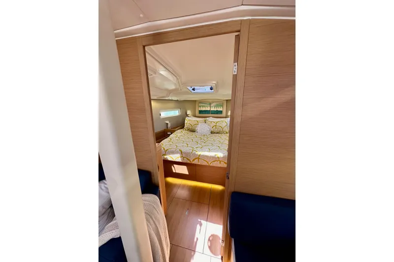 Slide: The Image of Cozy cabin interior of 2022 Jeanneau Sun Odyssey 410 sailboat, featuring a comfortable bed. - 74
