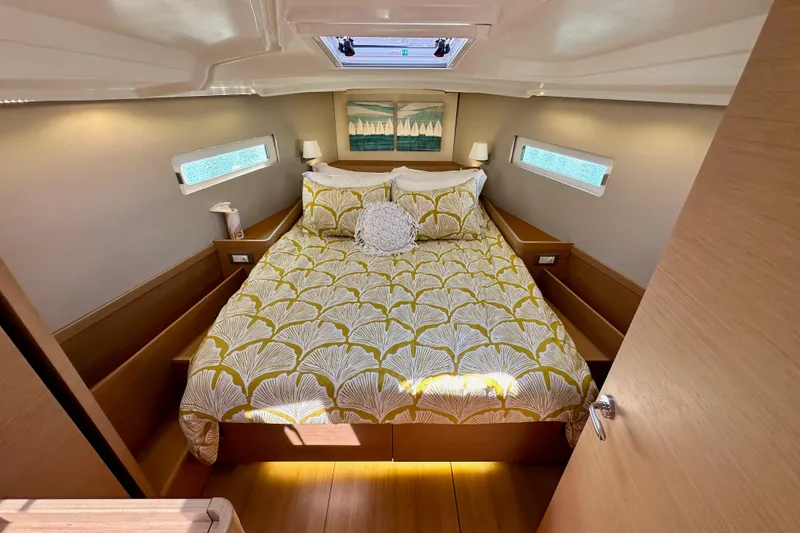 Slide: The Image of Luxurious cabin interior of 2022 Jeanneau Sun Odyssey 410 yacht with stylish bedding. - 75