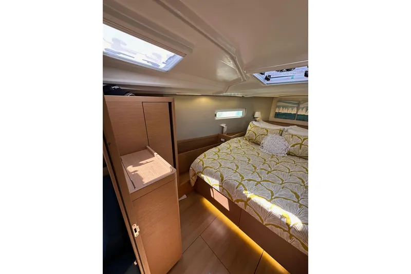 Slide: The Image of Luxurious interior cabin of 2022 Jeanneau Sun Odyssey 410 sailboat with cozy bedding. - 76