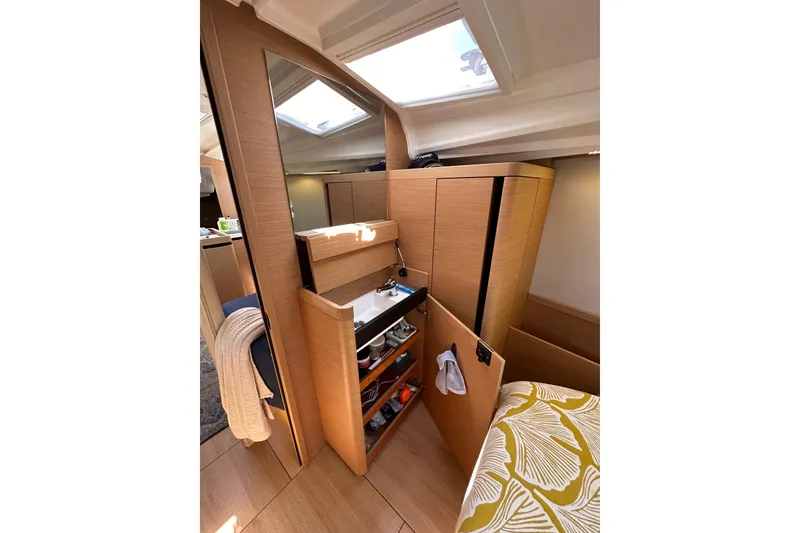 Slide: The Image of Interior of 2022 Jeanneau Sun Odyssey 410 yacht with modern wood cabinetry and compact sink. - 78