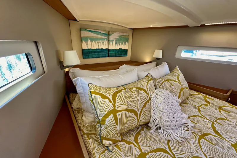Slide: The Image of Cozy cabin interior of 2022 Jeanneau Sun Odyssey 410 with stylish bedding and nautical decor. - 81
