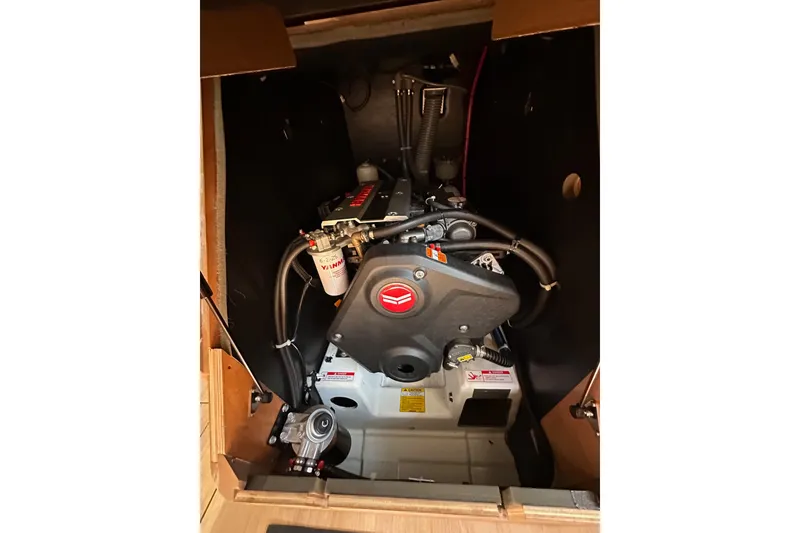 Slide: The Image of Engine compartment of 2022 Jeanneau Sun Odyssey 410 sailboat, showcasing mechanical components. - 92