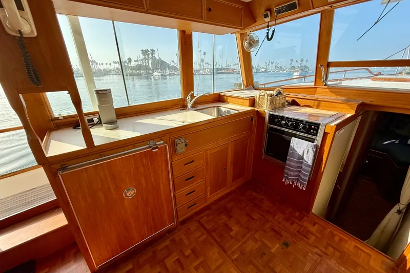 Slide: The Image of 1982 Grand Banks 42 Motoryacht kitchen with wooden cabinetry and ocean view. - 11
