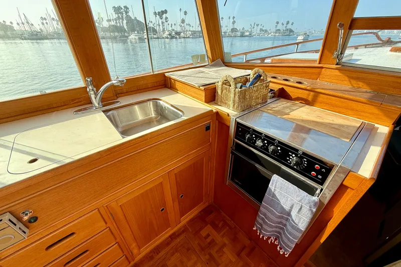 Slide: The Image of 1982 Grand Banks 42 Motoryacht kitchen with sink, stove, and ocean view. - 12