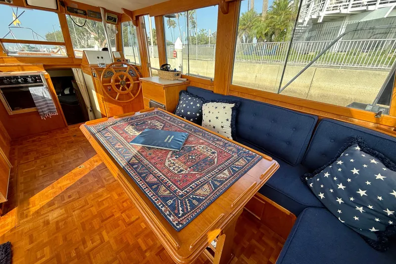 Slide: The Image of Interior of 1982 Grand Banks 42 Motoryacht with wooden decor and nautical-themed cushions. - 15